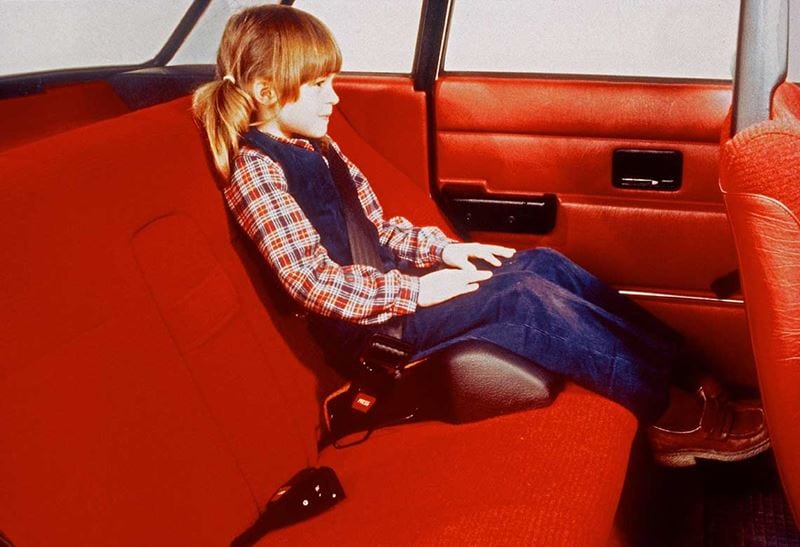 A girl sitting in a booster seat